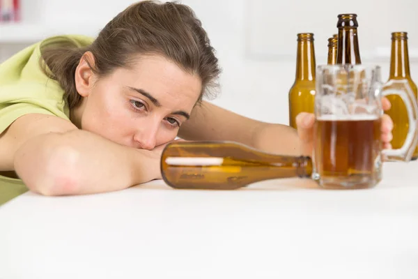 Drunk woman slumped on table — Stock Photo, Image