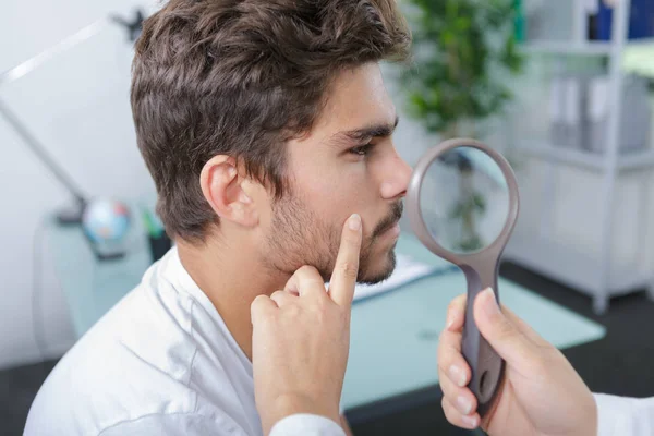 Close-up of doctors hands checking mans moles — Stock Photo, Image