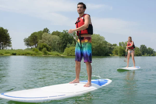 Silhouette of perfect couple engage standup paddle boarding — Stock Photo, Image