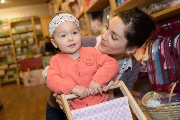 Young mother her daughter shopping at the toy store — Stock Photo, Image