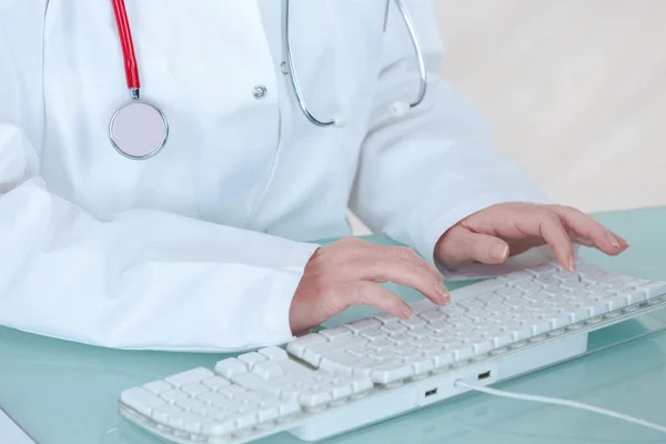 Médico femenino escribiendo en el ordenador portátil —  Fotos de Stock