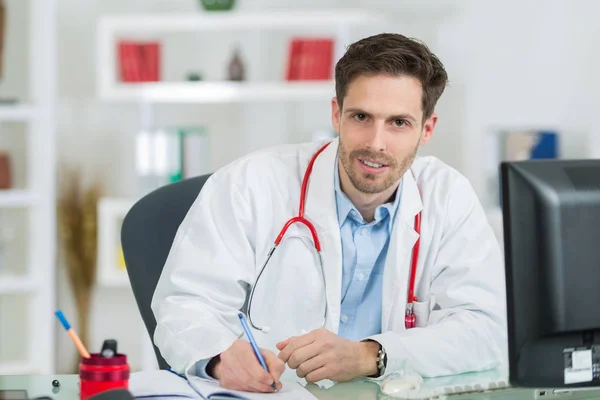 Medical physician doctor listening to patient and taking notes — Stock Photo, Image