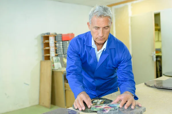 Homem organizando objetos na mesa — Fotografia de Stock