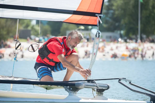 Professional waterman training on lake with catamaran — Stock Photo, Image