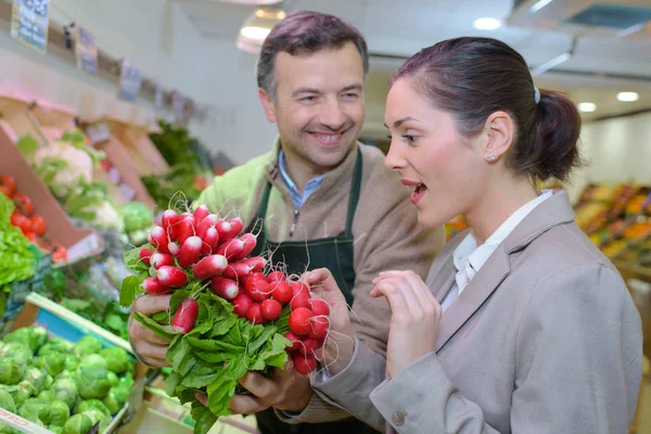 Gülümseyen kadın çiftliği gıda mağaza Vitrini, farklı meyve seçimi — Stok fotoğraf
