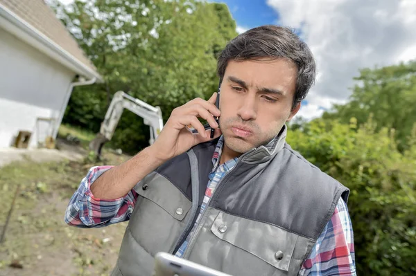 Unhappy one and backhoe — Stock Photo, Image