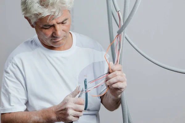 Electrician with plastic coated wiring — Stock Photo, Image
