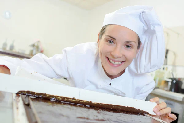 Chef showing tray of melted chocolate — Stock Photo, Image