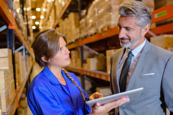 boss and employee in warehouse