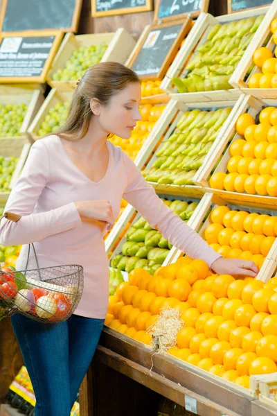 Жінка вибирає фрукти і жінка — стокове фото