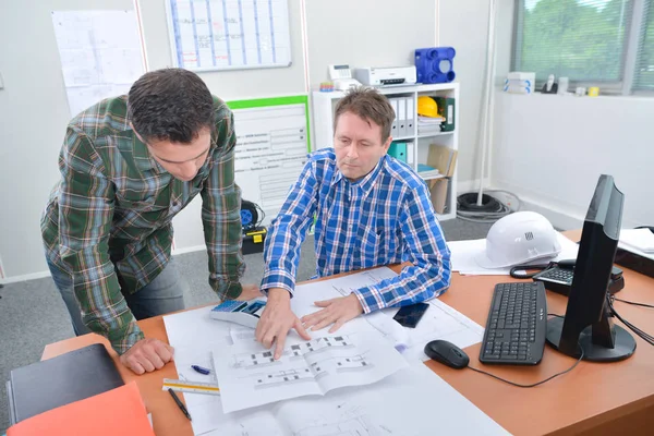 Employees examining a layout — Stock Photo, Image