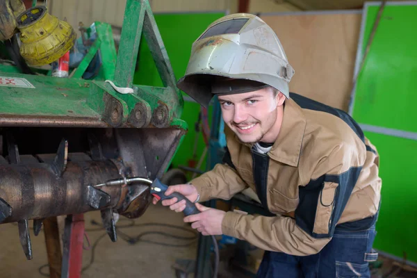 happy apprentice welder at work in the plant