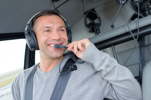 Smiling pilot in aircraft — Stock Photo, Image