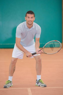 Portrait of man playing tennis clipart