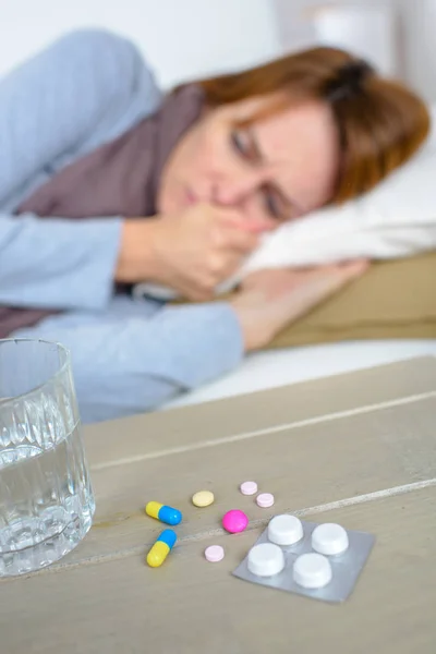 Sick woman laying on a sofa — Stock Photo, Image