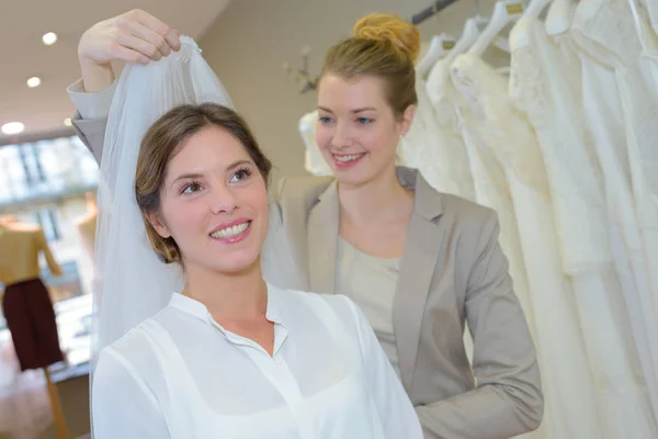 Fitting the veil and boutique Stock Image
