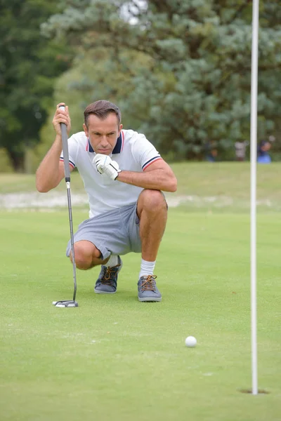 Чоловік середнього віку грає в гольф — стокове фото