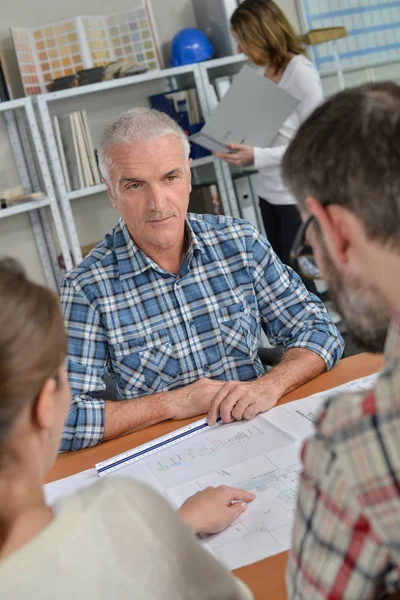 Uomo con clienti in ufficio — Foto Stock