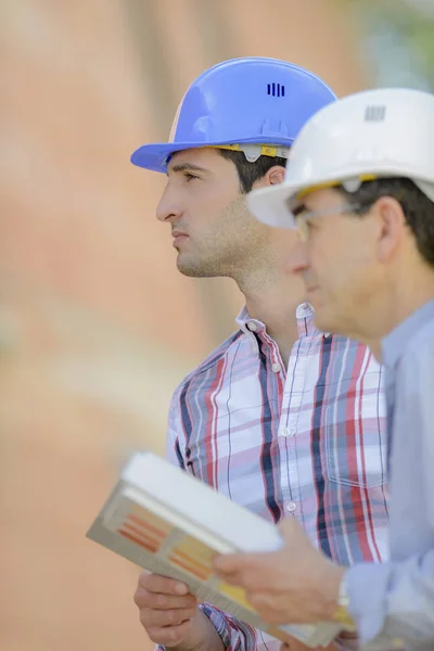 Men with helmet and architect — Stock Photo, Image