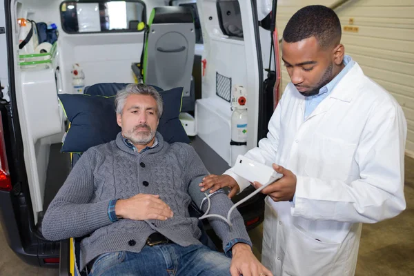 Paramédico tomando presión arterial del paciente —  Fotos de Stock