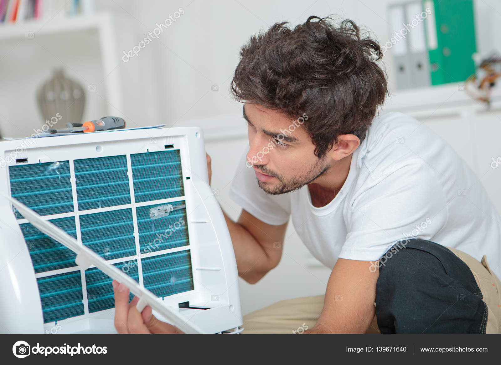 Man fixing air conditioning unit Stock Photo by ©photography33 139671640