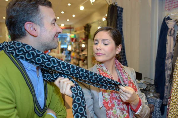 Young couple is chossing scarfs together — Stock Photo, Image