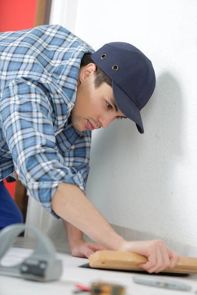 Assentamento de telhas cerâmicas piso - homem mão espalhando material adesivo — Fotografia de Stock