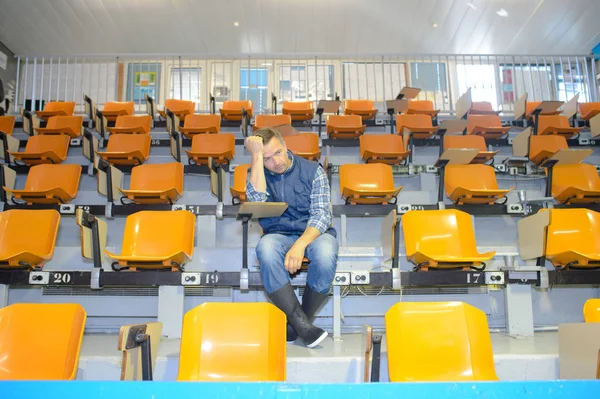 Man sitting alone in auditorium — Stock Photo, Image