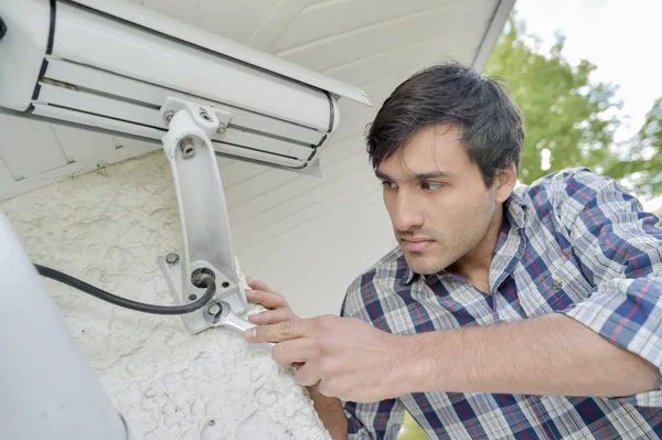 man installing video camera