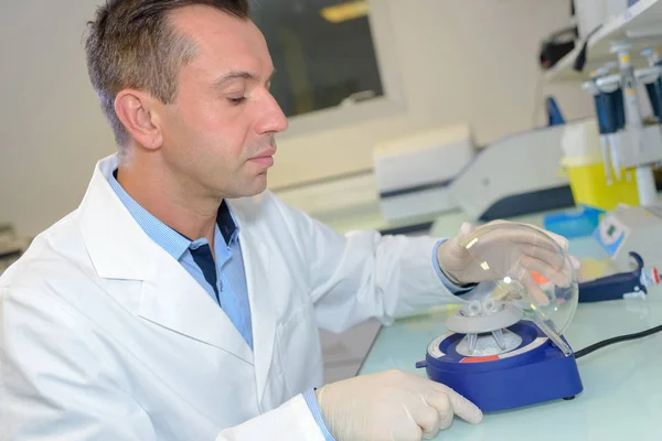 Technician with countertop centrifuge — Stock Photo, Image