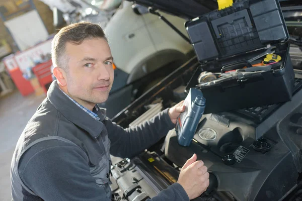 Auto mechanic repairman examining automobile car engine — Stock Photo, Image