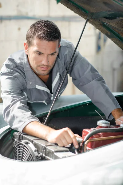 Uomo che cerca di riparare la sua auto — Foto Stock