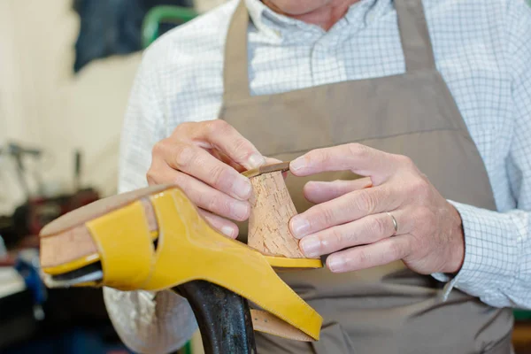 Cobbler mending heel of shoe — Stock Photo, Image