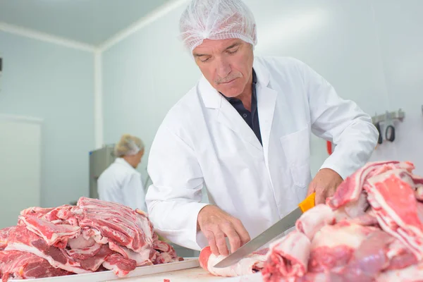 Butcher preparing cuts of meat