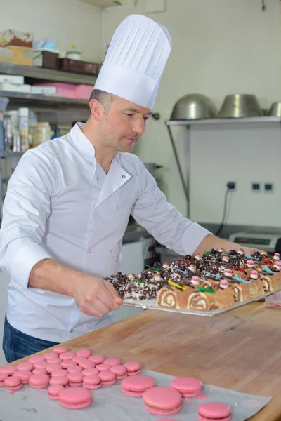 Confectioner carrying tray of cakes — Stock Photo, Image