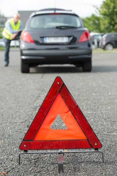 Gevarendriehoek achter vastgelopen auto — Stockfoto