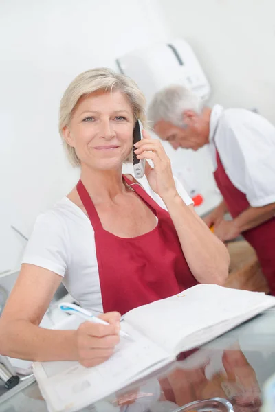 Boucher propriétaire téléphone et publicité — Photo