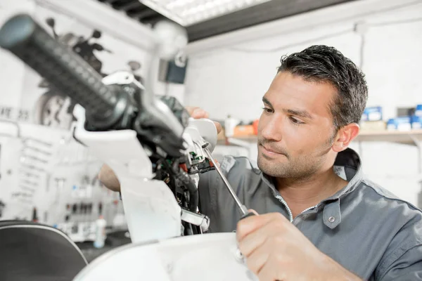 Man fixing scooter and young — Stock Photo, Image