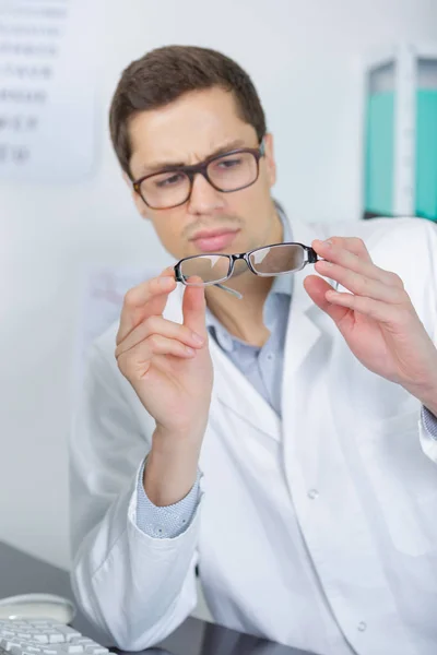 Young male doctor working in his office — Stock Photo, Image