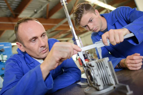 Delicate machine part and man — Stock Photo, Image