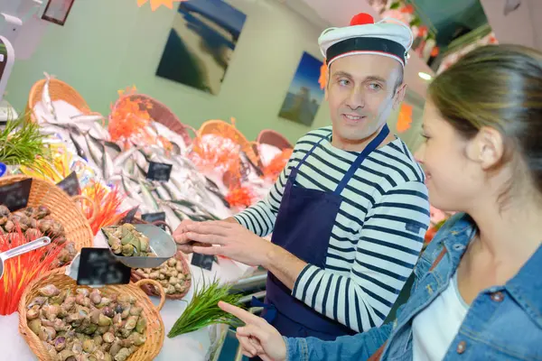 Seafood vendor wearing a french hat — Stock Photo, Image