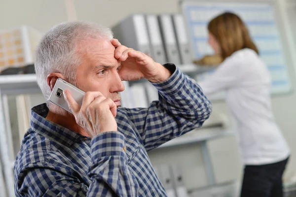 Doubtful boss on the phone — Stock Photo, Image