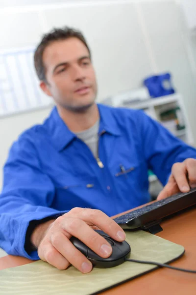 Hombre vistiendo overoles, escribiendo — Foto de Stock