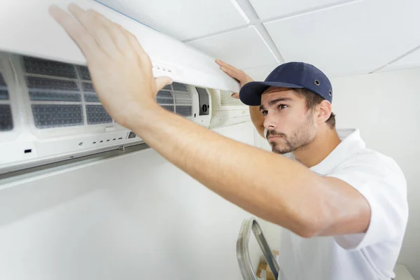 Chico de tecnología con cuidado la instalación de nuevo ac —  Fotos de Stock