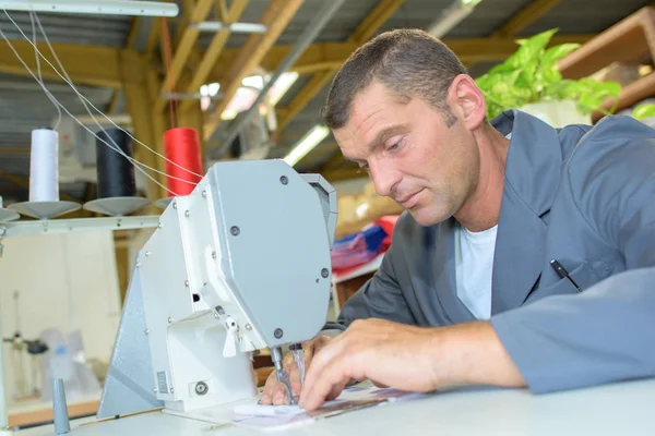 Man using sewing machine — Stock Photo, Image