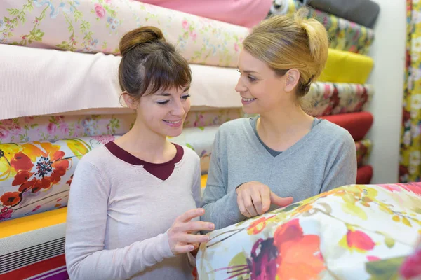 Women looking at floral material — Stock Photo, Image