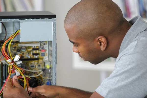 Man working on wiring of computer — Stock Photo, Image