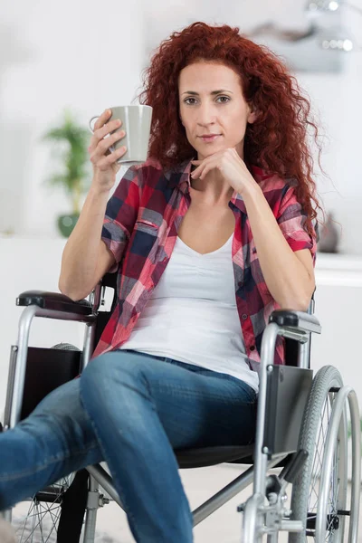 Happy handicapped woman having a cup of coffee — Stock Photo, Image