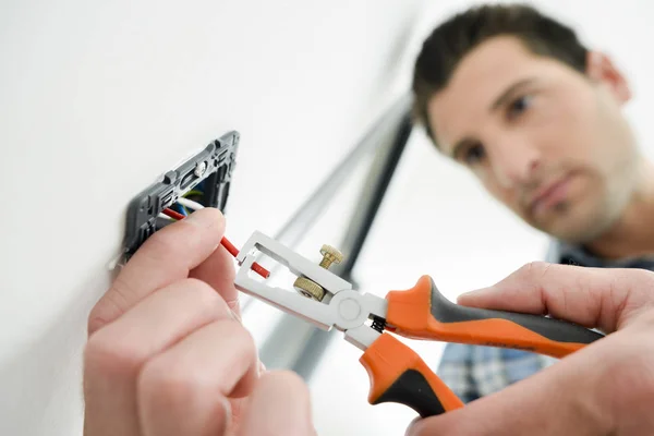Electrician fitting socket and young — Stock Photo, Image