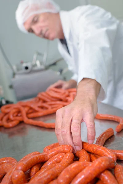 Butcher making sausages and butcher — Stock Photo, Image